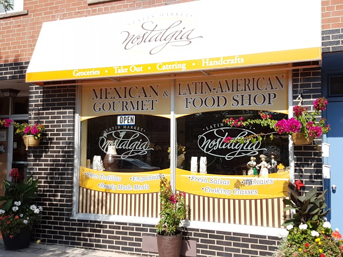 Nostalgia Mexican & Latin-American Food Shop exterior with flowers and sign.